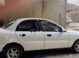 Daewoo Lanos SX 2002 - Cần bán gấp Daewoo Lanos SX đời 2002, màu trắng số sàn