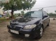 Mazda 323 2002 - Cần bán lại xe Mazda 323 sản xuất 2002, màu đen xe nguyên bản