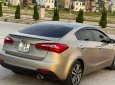 Kia K3   1.6 MT  2014 - Bán ô tô Kia K3 1.6 MT năm 2014, màu vàng cát, 350tr