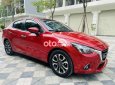 Mazda 2 2016 - Cần bán lại xe Mazda 2 AT sản xuất năm 2016, màu đỏ