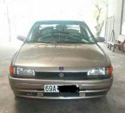 Mazda 323 1995 - Bán xe Mazda 323 đời 1995, màu vàng số sàn, 90 triệu