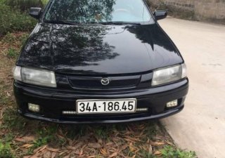 Mazda 323 MT 2000 - Bán Mazda 323 MT đời 2000, màu đen, xe nhập số sàn, 115 triệu