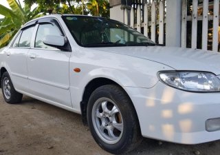Mazda 323 2004 - Cần bán Mazda 323 classic đăng ký 2004, màu trắng ít sử dụng, 170 triệu
