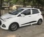 Hyundai Grand i10  1.2 AT 2015 - Cần bán gấp Hyundai Grand i10 1.2 AT đời 2015, màu trắng, nhập khẩu nguyên chiếc số tự động