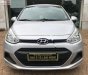 Hyundai i10 1.0MT Base 2014 - Cần bán gấp Hyundai i10 1.0MT Base 2014, màu bạc chính chủ