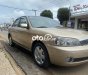 Ford Laser     2002 - Cần bán gấp Ford Laser đời 2002, màu vàng còn mới, giá 145tr